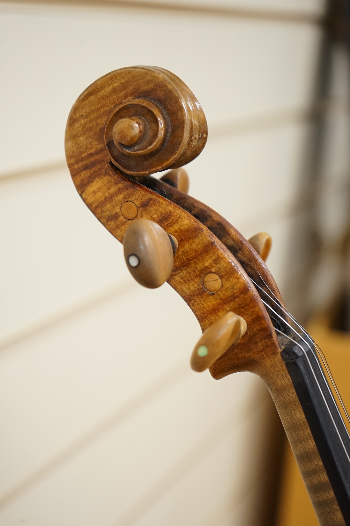 Five cased 20th century violins, including; a German violin, two Czech violins, a three-quarter size violin with a label for Bienfait, and a Romanian quarter size violin, all in cases or the remains of cases.
